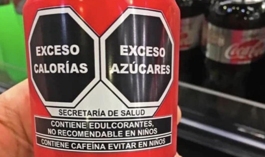 Black octagonal warning seals on packaged food products in Mexico